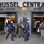 Police control the access to the central train station following bomb attacks in Brussels, Belgium