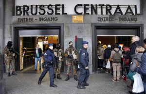 Police control the access to the central train station following bomb attacks in Brussels, Belgium