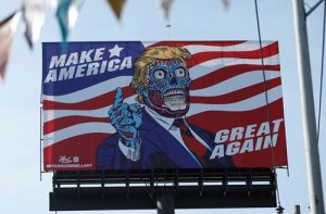 A giant billboard shows a drawing depicting U.S. President Trump in Mexico City