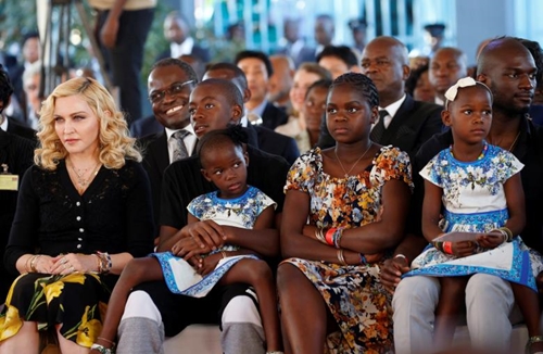 Madonna sits with her adopted children during the opening of Mercy James hospital in Blantyre