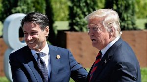 Leaders shake hands as they pose for family photo at the G7 Summit in La Malbaie