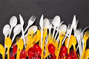 Top view on plastic forks at black background