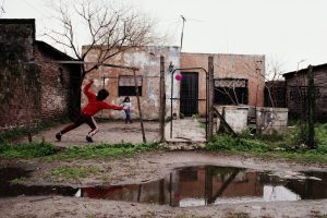 Argentina, Buenos Aires, children playing in yard outside house