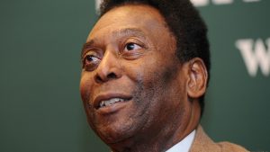 Pele Signs Copies Of "Why Soccer Matters"